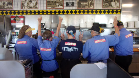 Waffle House workers wearing HAPPINESS signs on their uniforms